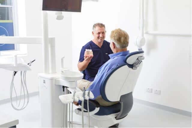 A patient discusses missing teeth with Dr Daniel Adamo at Dental Implants on Miller